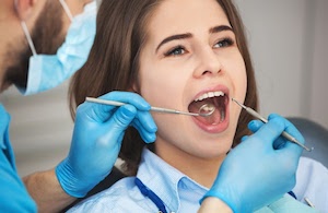 Girl getting her teeth cleaned at the dentist